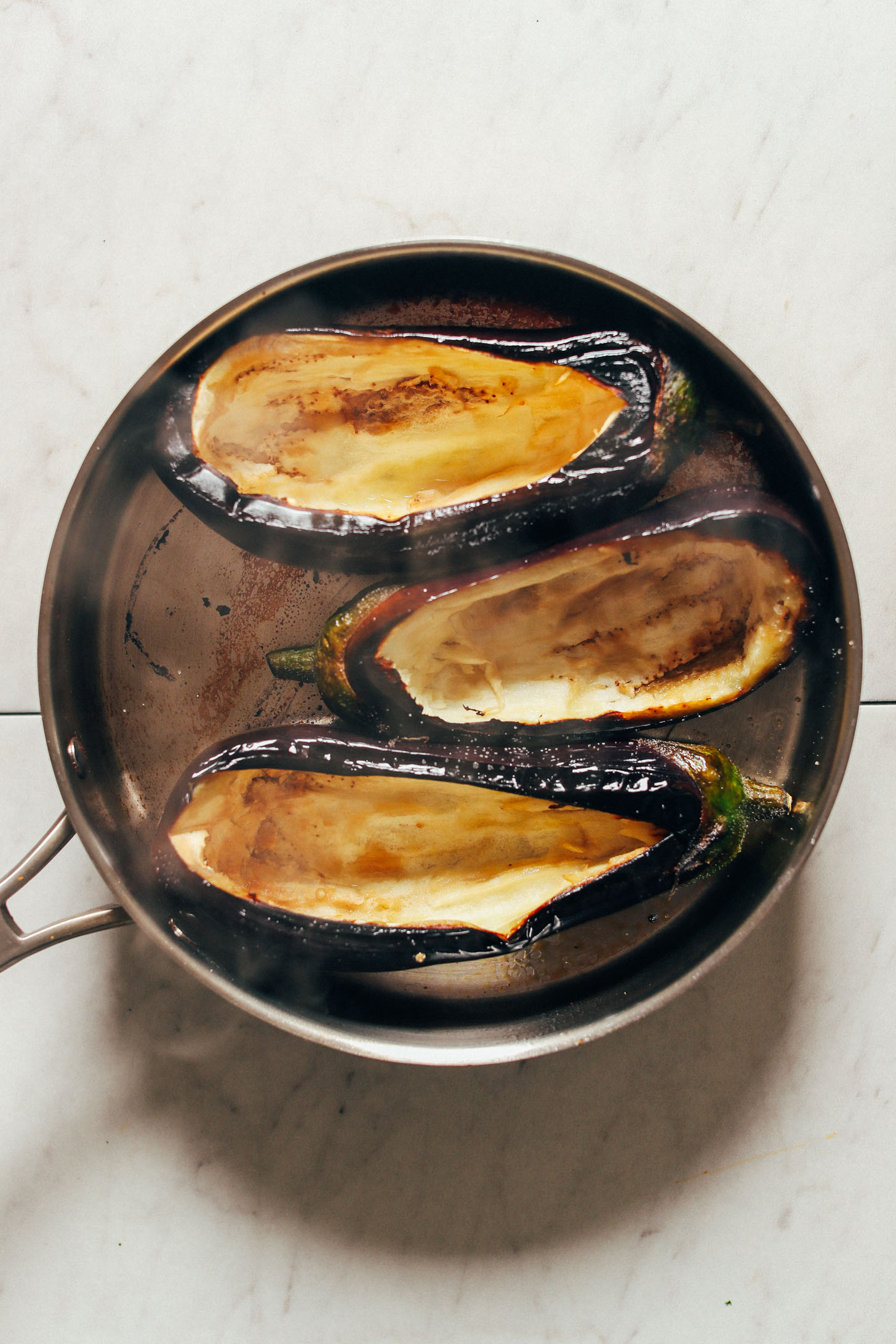 Nicely charred eggplants in a large saute pan