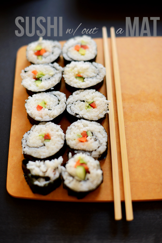 Sliced Vegan Sushi Rolls on a cutting board with chopsticks